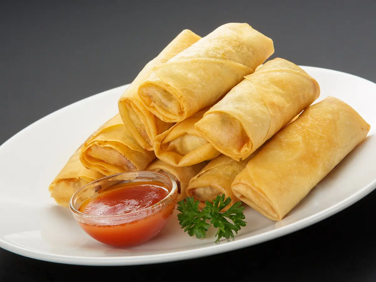 Crispy fried egg rolls filled with savory vegetables and meat, served with sweet and sour sauce at Cheng's Asian Cuisine，a Asian Restaurant in Winchester